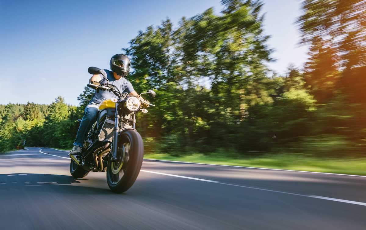 Rider with Motorcycle insurance on a street