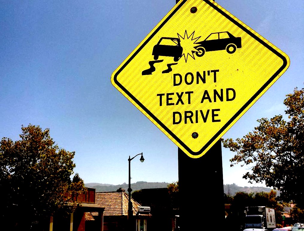 A sign that reads "don't text and drive" discourages texting while driving