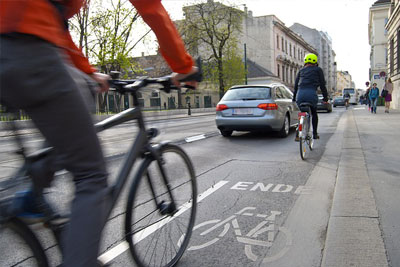 Cyclists on a busy road take measures to avoid bicycle accidents, like wearing the correct gear.