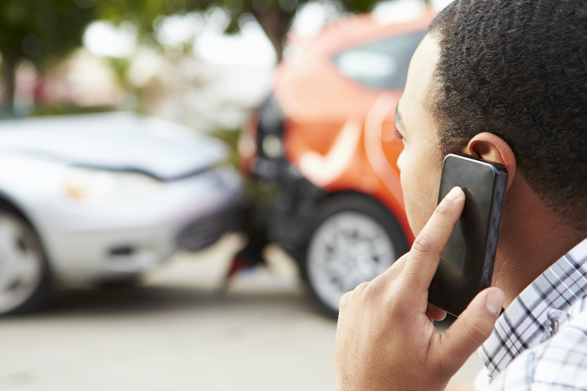 A man is calling a top rated car accident lawyer after his car is hit by someone else