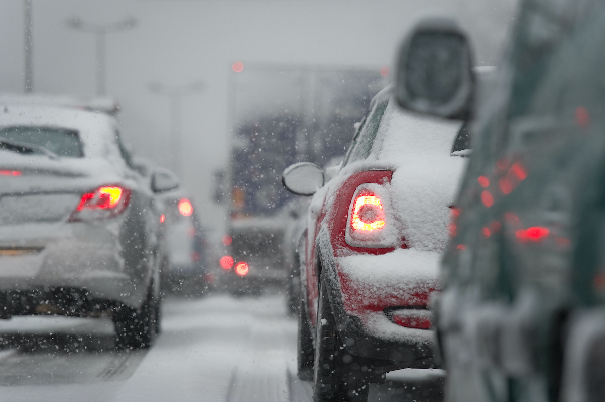 Drivers following our driving tips drive in the winter. Cars are covered in snow.